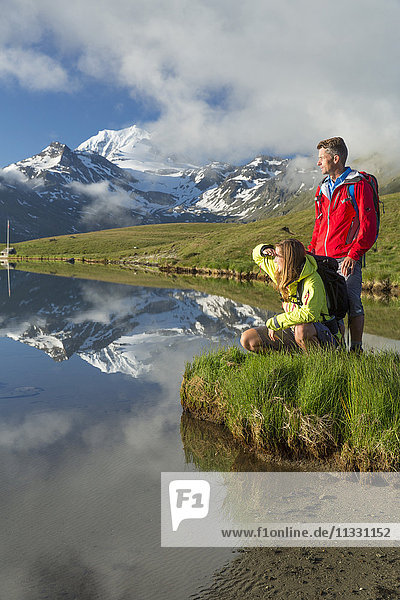 Couple hiking at Gibidumsee lake in Valais