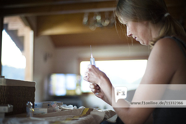 Reportage on an independent nurse in Haute-Savoie  France. Aline travels round her small mountain town every day to meet her patients. She also has a practice in town that she shares with two other colleagues. Aline prepares a syringe.