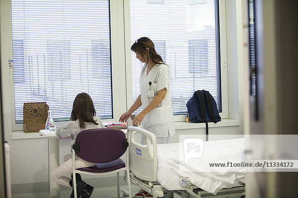 Reportage in the pediatric unit in a hospital in Haute-Savoie  France. A auxiliary nurse talks to a young patient.