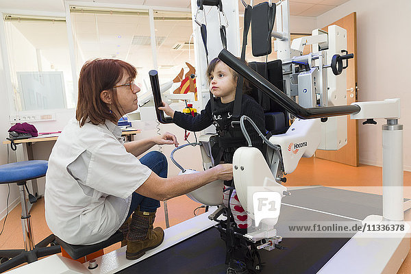 Reportage on the Rossetti health centre in Nice  France. This rehabilitation centre is a hub of excellence with cutting-edge technology. The Rossetti Motor Function Education Institute is the first French establishment to have a pediatric Lokomat PRO V6  an automated walking orthosis enabling intensive walking rehabilitation on a treadmill. This 4-year old girl suffers from neurological disorders and is late walking. She is having a training session with a physiotherapist.