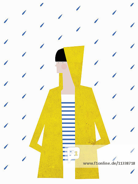 Mädchen trägt einen gelben Regenmantel mit Kapuze im Regen