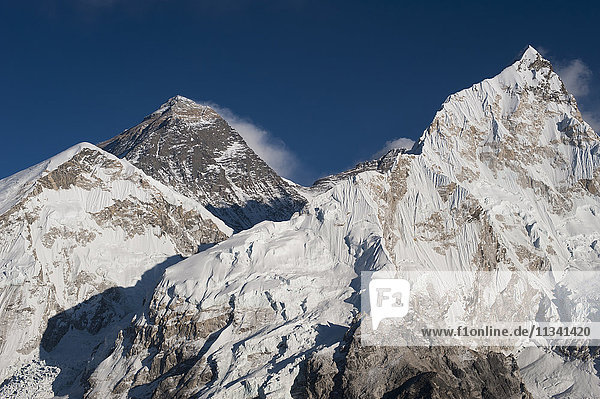 The massive black pyramid summit of Mount Everest seen from Kala Patar with Nuptse the other peak to the right Khumbu Region Nepal Himalayas Asia