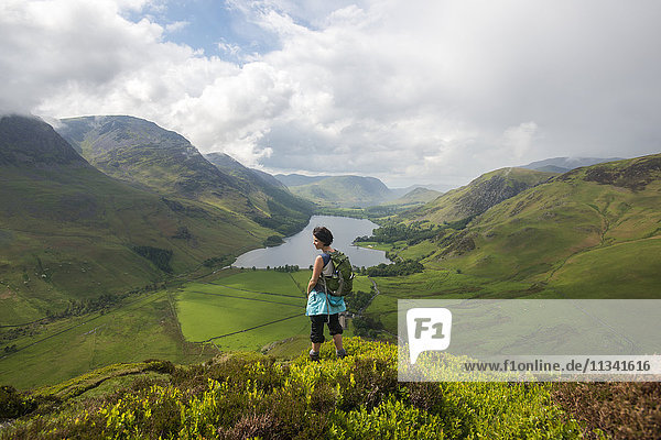 A woman looks out over Buttermere from Fleetwith Pike  Lake District National Park  Cumbria  England  United Kingdom  Europe