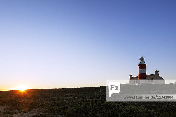 Agulhas lighthouse at southernmost tip of Africa at sunset  Agulhas National Park  Western Cape  South Africa  Africa