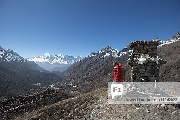 A trekker in the Everest region looks down on the Khumbu Valley towards Pangboche  Khumbu Region  Himalayas  Nepal  Asia