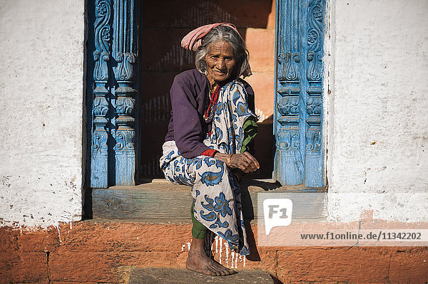 A old woman sits outside her house in Uttarakhand  India  Asia