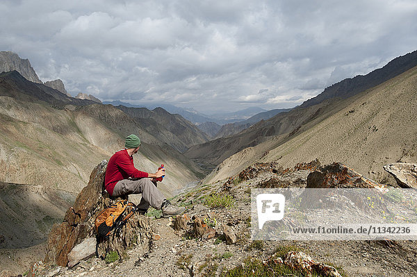 Stopping to savour the views from the top of the Konze La  at 4900m  during the Hidden Valleys trek in Ladakh  a remote Himalayan region  India  Asia