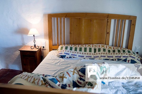 old unmade bed in a house.