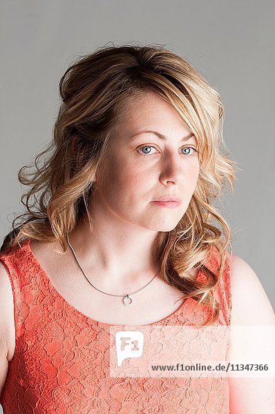 Serious blond woman looking away.