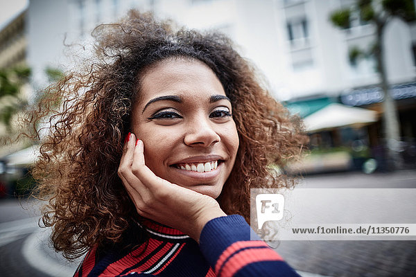 Portrait of smiling young woman in the city