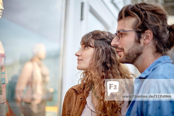 Young couple looking in shop window