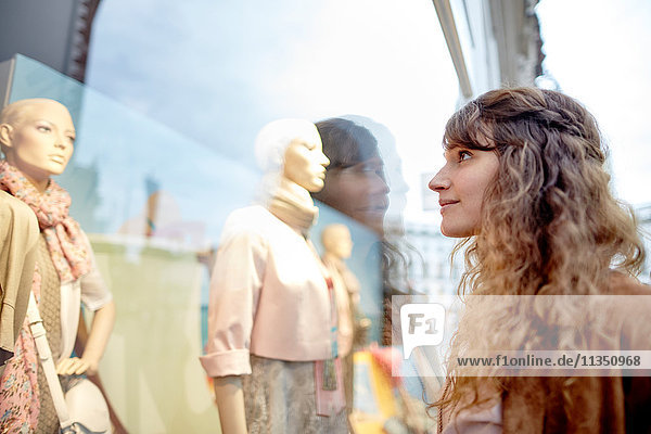 Young woman looking in shop window