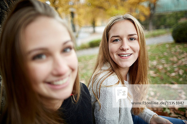 Two smiling young women outdoors