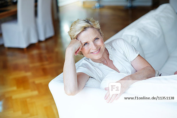 Portrait of smiling mature woman on Sofa