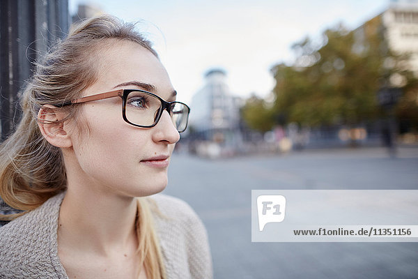 Young woman looking sideways in the city