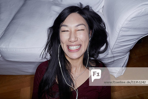 Happy young woman with earbuds