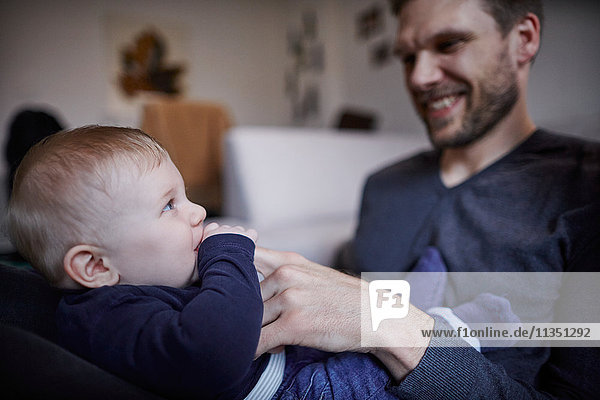 Relaxed father with baby at home