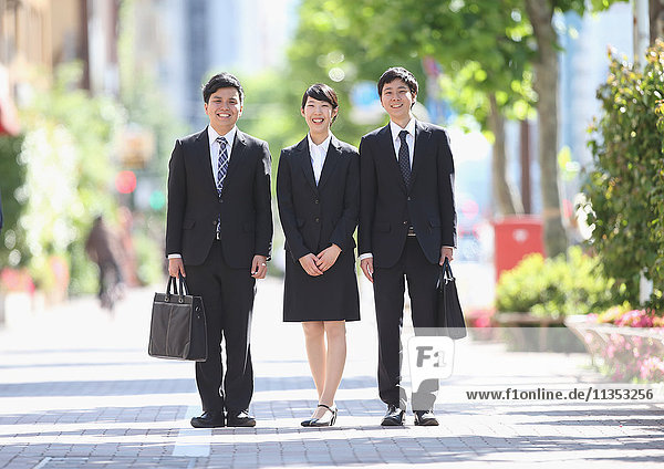 Young Japanese businessmen at city park