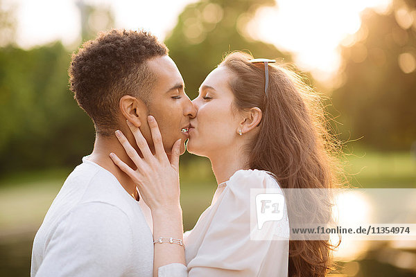 Side view of young couple kissing