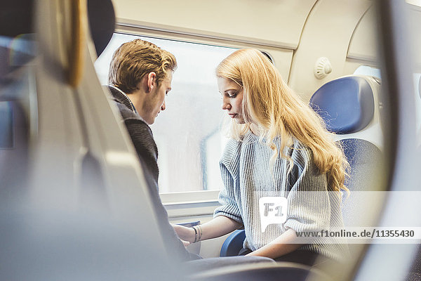 Young couple in train carriage  Italy