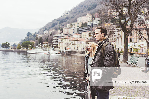 Young couple looking out on lakeside  Lake Como  Italy
