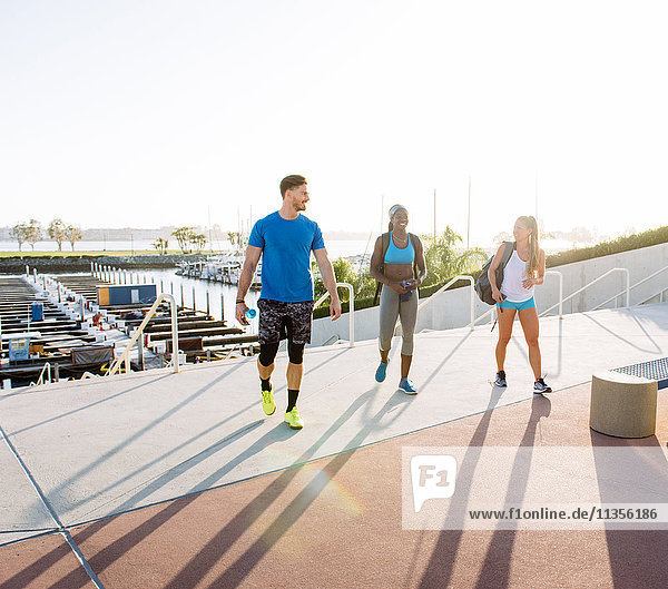 Man and two young women training talking in sport facility downtown San Diego California USA