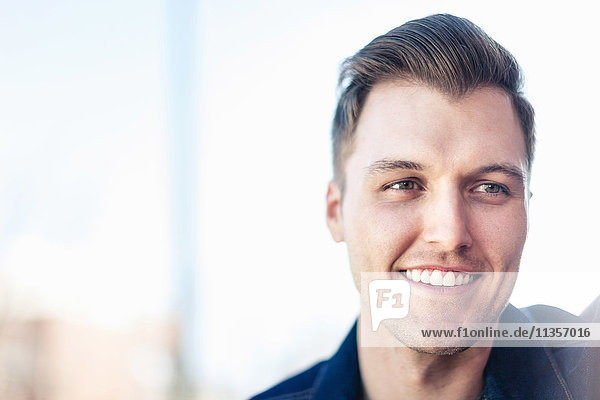 Portrait of smiling young man looking away