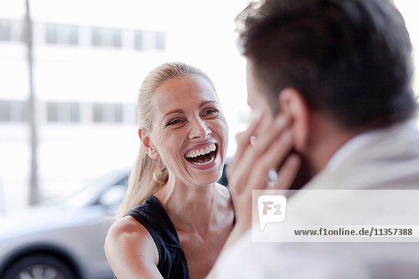 Mature man and woman  face to face  woman touching man's face  laughing