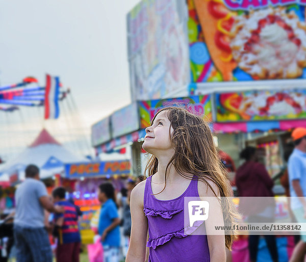 Cute girl looking over her shoulder in amusement park