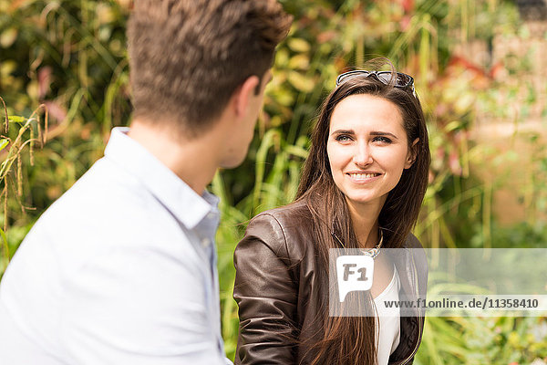 Young businessman and businesswoman talking in city