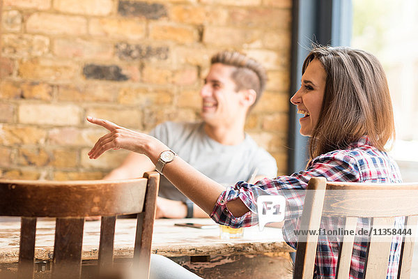 Young couple pointing in bar