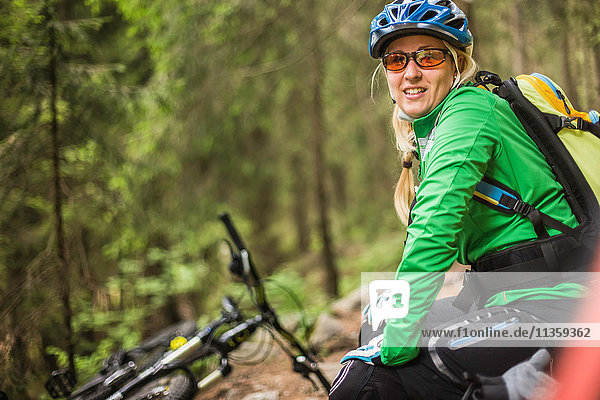 Woman mountain biker looking at camera smiling  Meran  South Tyrol  Italy