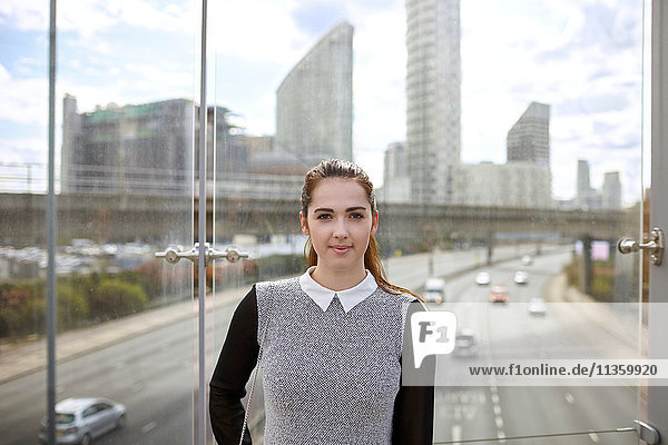 Portrait einer jungen Geschäftsfrau auf der Fußgängerbrücke  London  UK