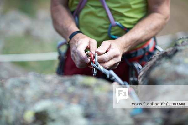 Cropped view of rock climber preparing climbing rope