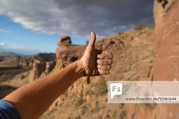 Rock climber giving thumbs up sign  close-up  Smith Rock State Park  Oregon  USA