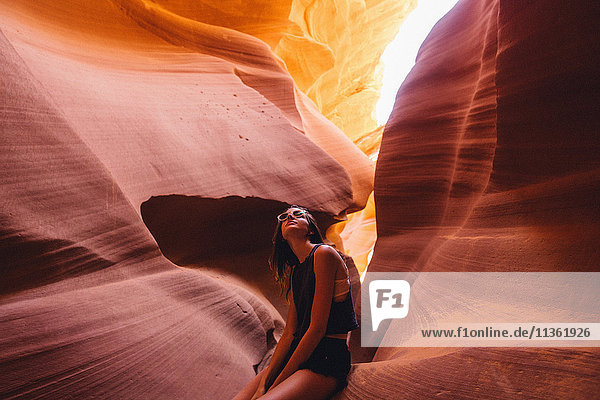 Woman looking up at sunlight in cave  Antelope Canyon  Page  Arizona  USA