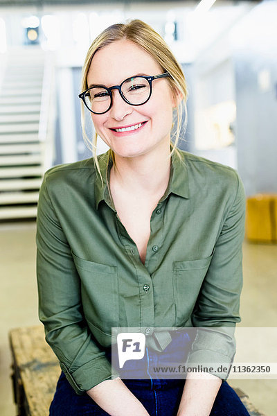 Portrait of woman wearing glasses looking at camera smiling