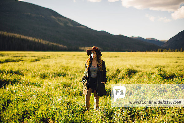 Woman walking in meadow,  Rocky Mountain National Park,  Colorado,  USA
