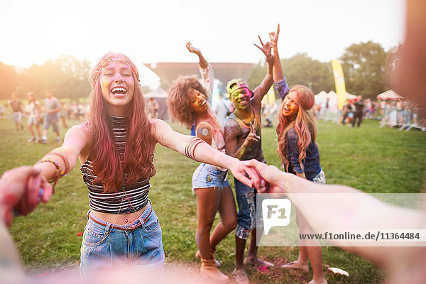 Group of friends at festival  covered in colourful powder paint