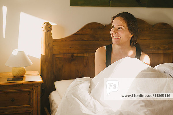 Woman smiling in bed