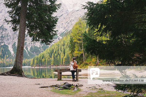 Woman leaning against park bench  Lago di Braies  Dolomite Alps  Val di Braies  South Tyrol  Italy