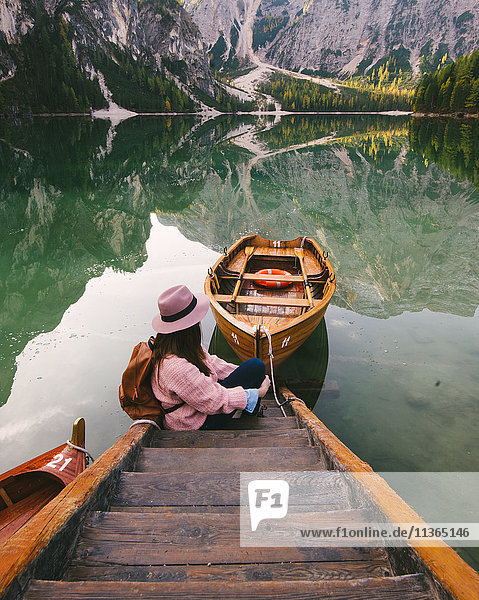 Woman relaxing on pier  Lago di Braies  Dolomite Alps  Val di Braies  South Tyrol  Italy