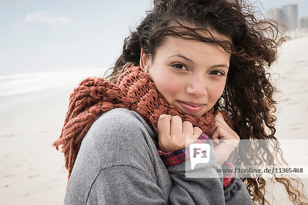 Portrait of young woman wrapped in scarf on windy beach  Western Cape  South Africa
