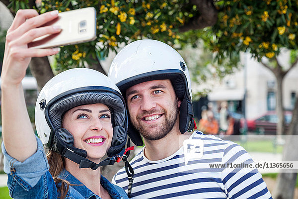 Young moped couple taking selfie in park  Split  Dalmatia  Croatia
