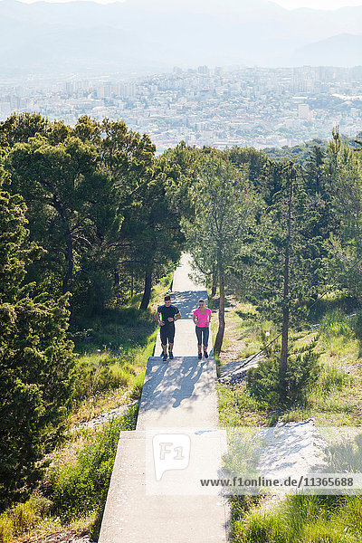 Young man and woman running in park  Split  Dalmatia  Croatia