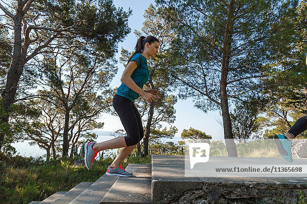 Female runner running up park stairway  Split  Dalmatia  Croatia