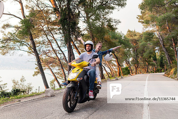 Couples riding moped on rural road  Split  Dalmatia  Croatia