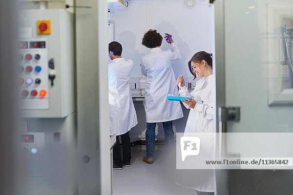 View through doorway of scientists in laboratory