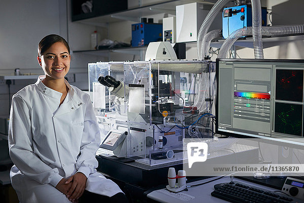 Portrait of scientist in laboratory looking at camera smiling