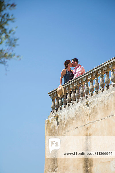 Couple kissing on rooftop balcony at boutique hotel  Majorca  Spain